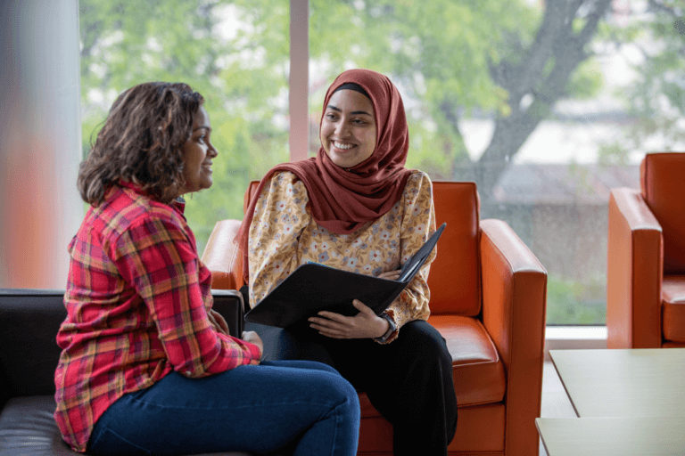 Two students having a conversation on campus.